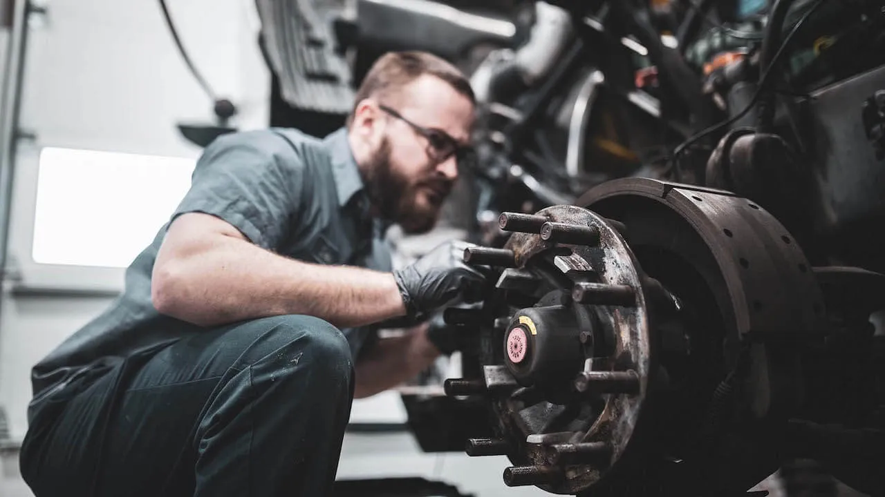 Mechanic performing truck brake repair